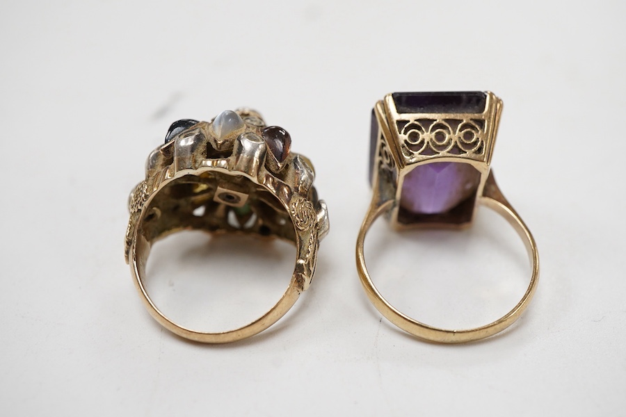 A yellow metal and single stone emerald cut amethyst set dress ring, size Nm together with an Indian? yellow metal and multi gem set ring.